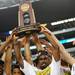 Michigan basketball holds their NCAA South Regional Champion trophy as they celebrate being Florida in the Elite Eight and advancing to the Final Four at Cowboys Stadium on Sunday, March 31, 2013. Melanie Maxwell I AnnArbor.com
